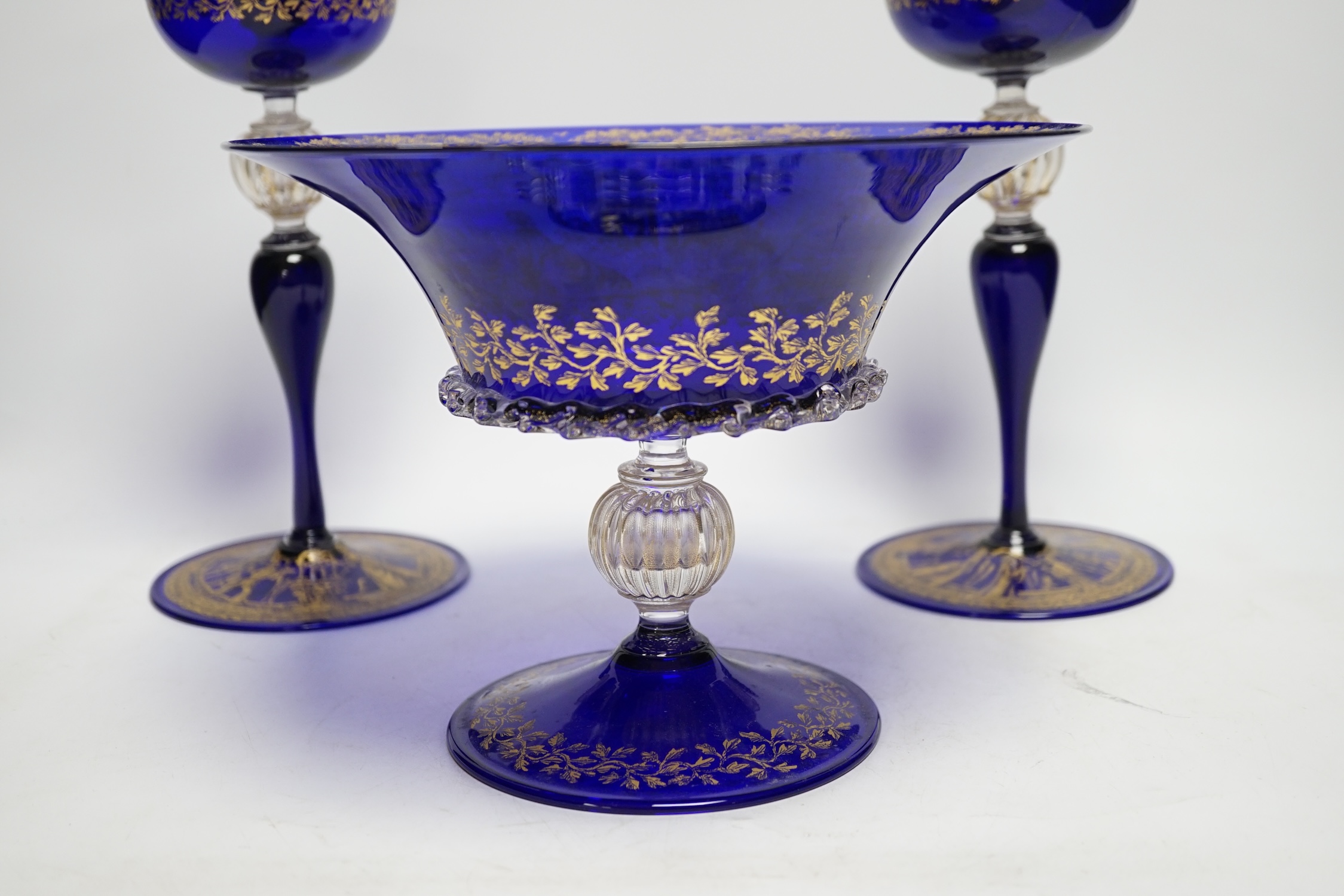 A Venetian gilded glass pedestal dish and a pair of candle holders, 26cm